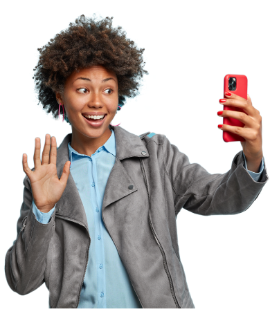 charming-positive-dark-skinned-friendly-woman-enjoys-informal-meeting-online-waves-palm-says-hi-smartphone-uses-video-messanger-takes-selfie-wears-stylish-grey-jacket-greets-friend 1